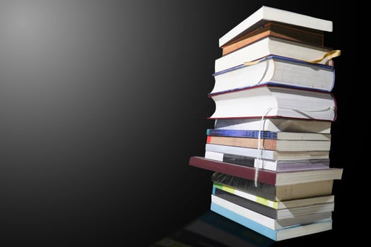 books stacked vertically on a black background photo