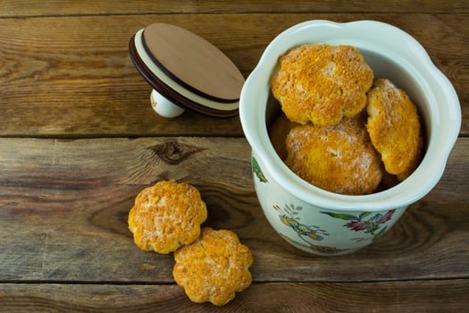Cookies in a porcelain jar on rustic wooden background photo