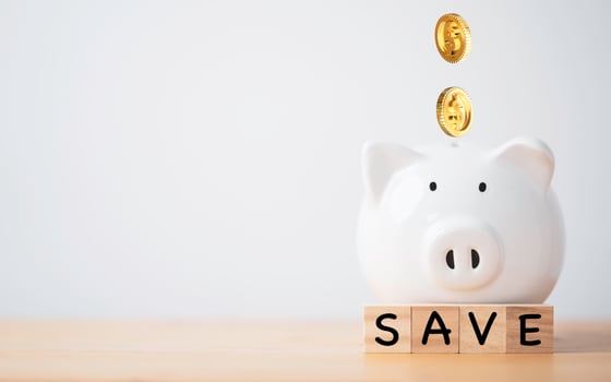 White piggy bank saving with golden coins falling for deposit and money saving investment concept. photo