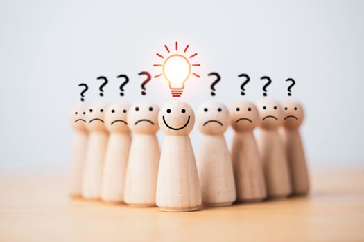Smiley wooden human with light bulb and others human with question mark for creative thinking and problem solving solution concept. photo