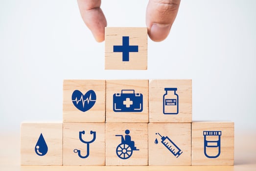 Hand putting and stacking Healthcare and medical icons which print screen on wooden cube block for health insurance concept. photo