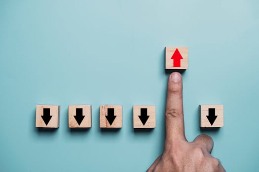 Finger pushing red up arrow which it opposite direction from black down arrow for business disruption and leadership concept. photo