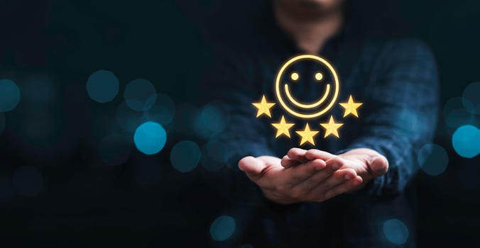 Businessman holding smile icon for the best evaluation , customer satisfaction concept. photo
