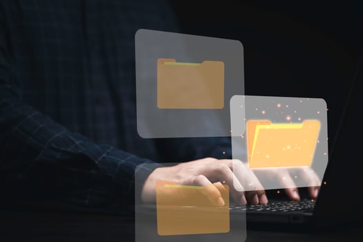 Businessman using computer laptop with virtual folder graphic for online document database management concept. photo