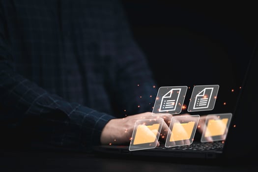 Businessman using computer laptop with virtual folder graphic for online document database management concept. photo