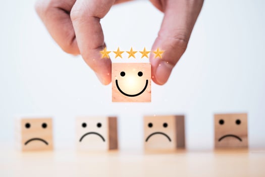 Hand holding smiley face with five golden stars for client evaluate product and service, customer satisfaction concept. photo