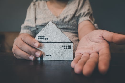 Housing Loan and Real Estate Broker Selling Agency Concept. Business Woman Hands Offer House Model to Customer for Sale,Rent. Business House Realty Agent and Residential Investment. photo