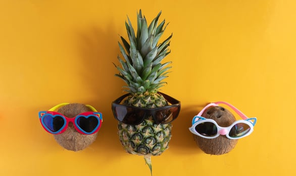 A smart pineapple in sun glasses and bright beads. Minimal concept, summer tropical pineapple.Summer, vacation, party photo