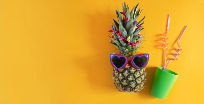 A smart pineapple in sun glasses and bright beads.Minimal concept, summer tropical pineapple. photo
