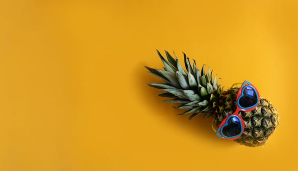 Pineapple hipster in sunglasses. Minimal concept, summer tropical pineapple. photo
