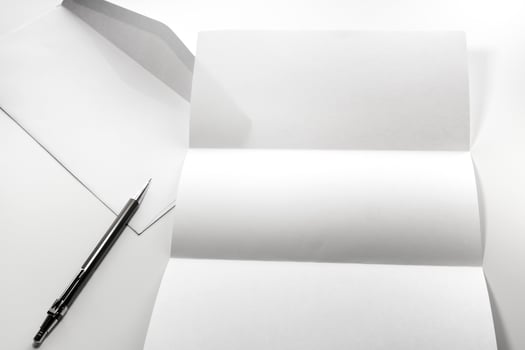 blank of letter paper and white envelope with pen photo