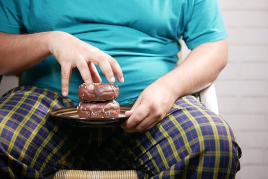 young man eating donut , selective focus photo