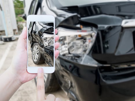 female hold mobile smartphone photographing car accident photo