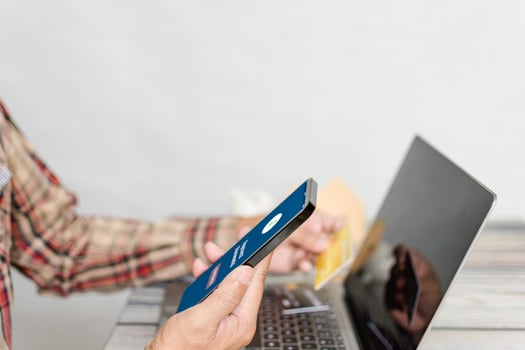 Male shoppers holding smartphones and payment successful. Concept for mobile, laptop, phone, casual, smartphone, shopping, smile, happiness. Copy space upper side. Selective focus. Blurred background photo