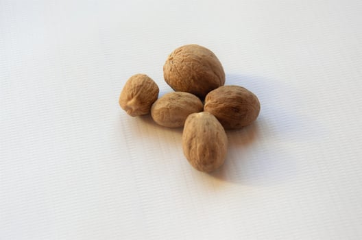 nutmeg on a white background, seasoning. minimalism photo