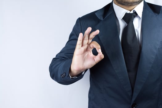 Businessman with okay in his finger photo