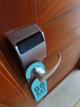 hanger do not disturb sign on electronic lock door photo