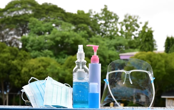Hand sanitizer gel and facemasks to clean hands and wear before getting inside to protect and prevent Covid-19 virus or Coronavirus and germs. photo