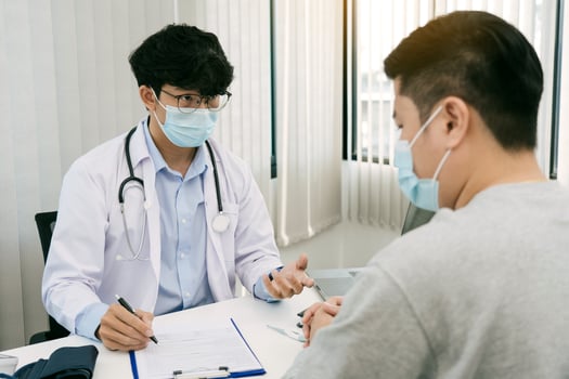 Doctors are explaining the treatment of a patient's illness while wearing a mask during the epidemic. photo