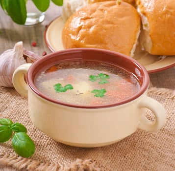 Chicken soup in the brown ceramic bowl photo