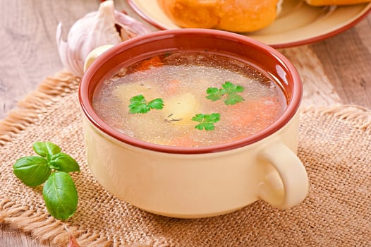 Chicken soup in the brown ceramic bowl photo