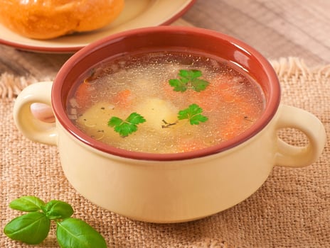 Chicken soup in the brown ceramic bowl photo