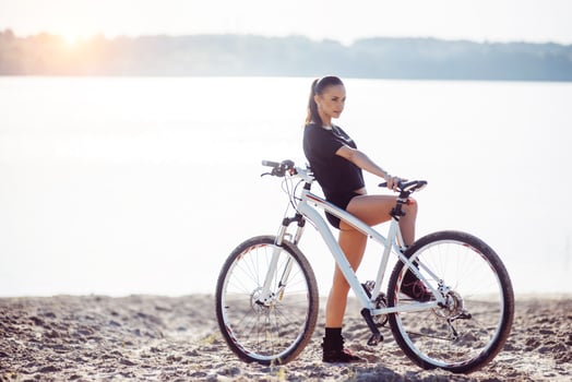 woman on a bicycle near the water photo