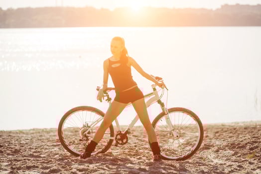 woman on a bicycle near the water photo