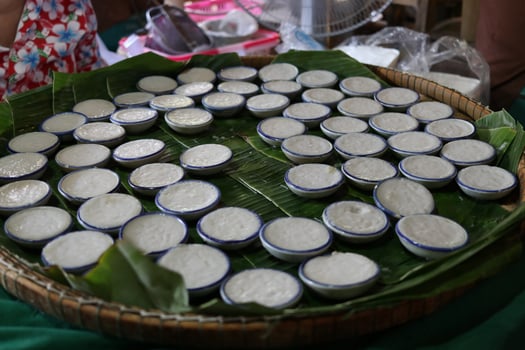 Coconut milk custard in cups on bamboo plate. photo