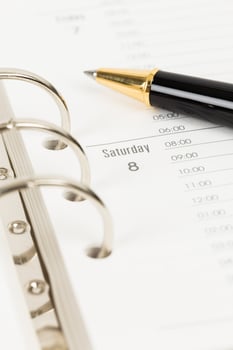 Calendar page organizer notebook weekend Saturday with pen photo