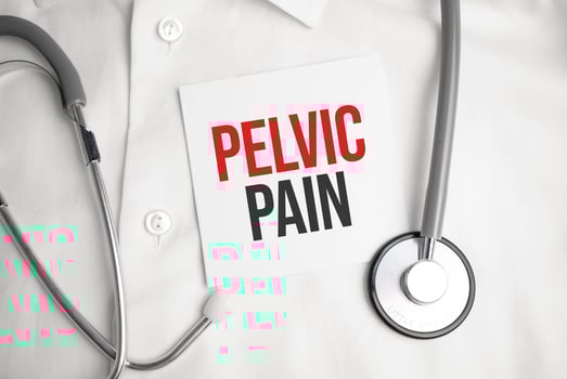 Paper with text PELVIC PAIN on a table with stethoscope photo