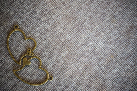 Heart pendant on old fabric, texture background, valentine concept photo