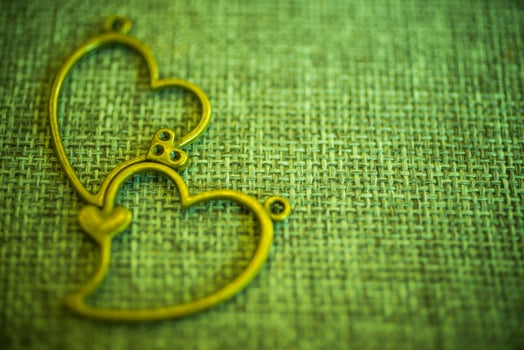 Heart pendant on old fabric, texture background, valentine concept photo