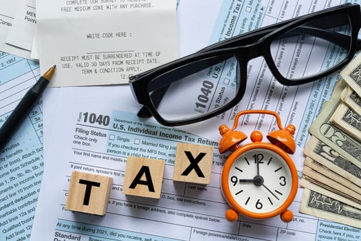 Text on Alphabet wooden block cube with Tax forms 1040. U.S Individual Income Tax photo