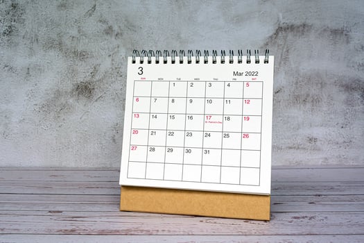 White March 2022 calendar on wooden desk. 2022 new year concept. photo