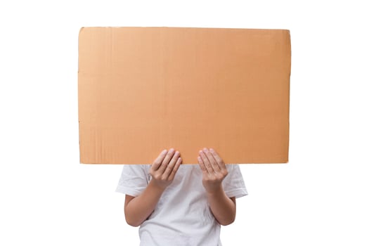 Little girl hands showing brown paper cardboard isolated on white background, with clipping path. photo