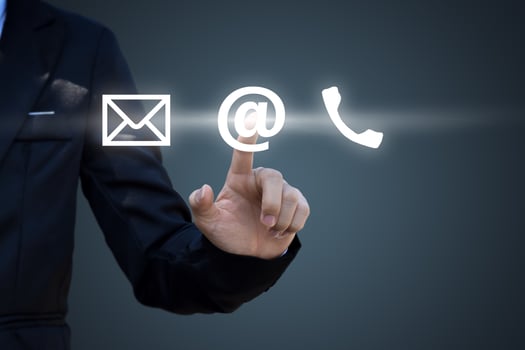 Hand pressing telephone, email button icon over blue background. Customer support concept photo