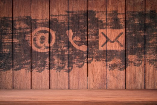 Contact Us. Phone, email and post icons paint on wood wall photo