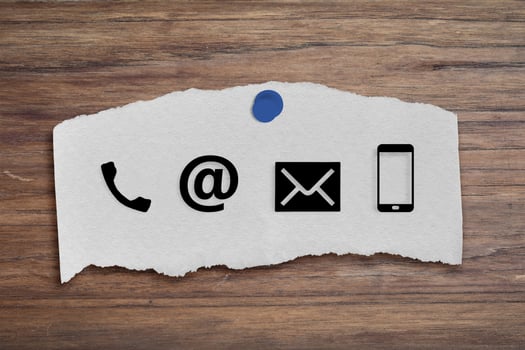 CONTACT US Icons on post it on wood table. Concept of business or customer service. photo