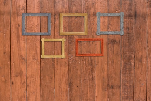 Vintage photo frames on wood wall for interior or background.