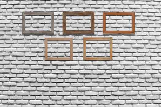 Vintage photo frames on brick wall for interior or background.