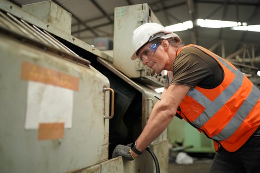 Maintenance Engineers is working in front of the automated CNC machinery repair on a maintenance checklist at the production line. photo