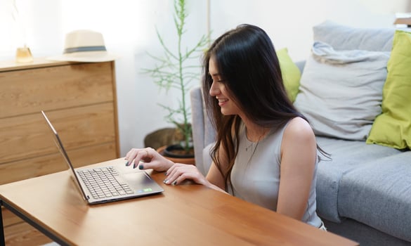 Young beautiful woman using a laptop at home photo