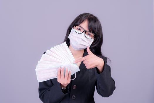 Asian business women have to use a mask to cover the face to prevent pollution from dust photo
