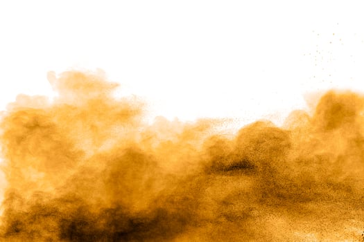 Freeze motion of brown dust explosion on white background.Stopping the movement of brown Holi powder. photo