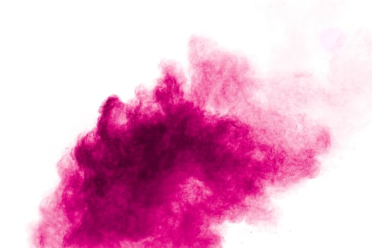 Explosion of pink colored powder isolated on white background.Pink dust splash. photo