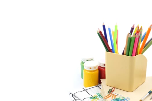 Stationery background - Color pencils ,clip binder and poster color on white photo