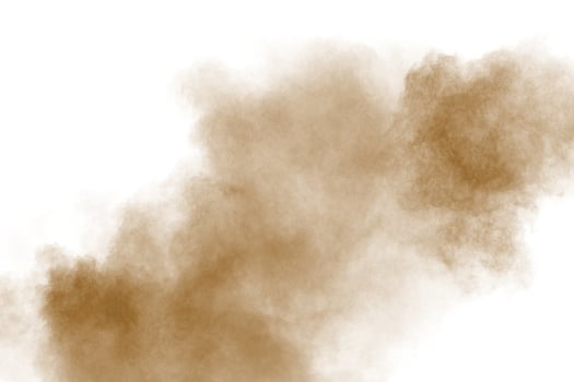 Brown color powder explosion cloud  on white background.Brown dust splashing on  background. photo
