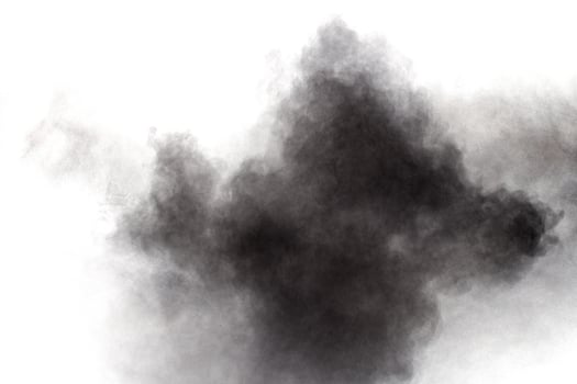 Black powder explosion on white background.Black dust particles splash. photo