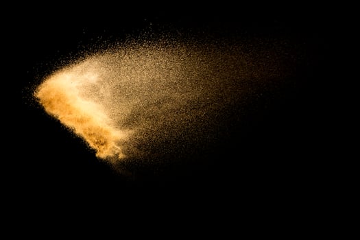 Dry river sand explosion isolated on black background. Abstract sand cloud.Brown colored sand splash against dark background. photo